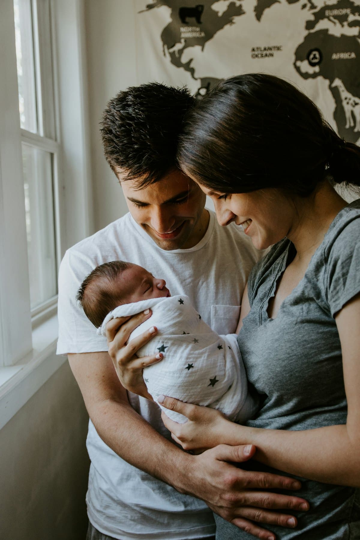 Parents smiling at their newborn baby