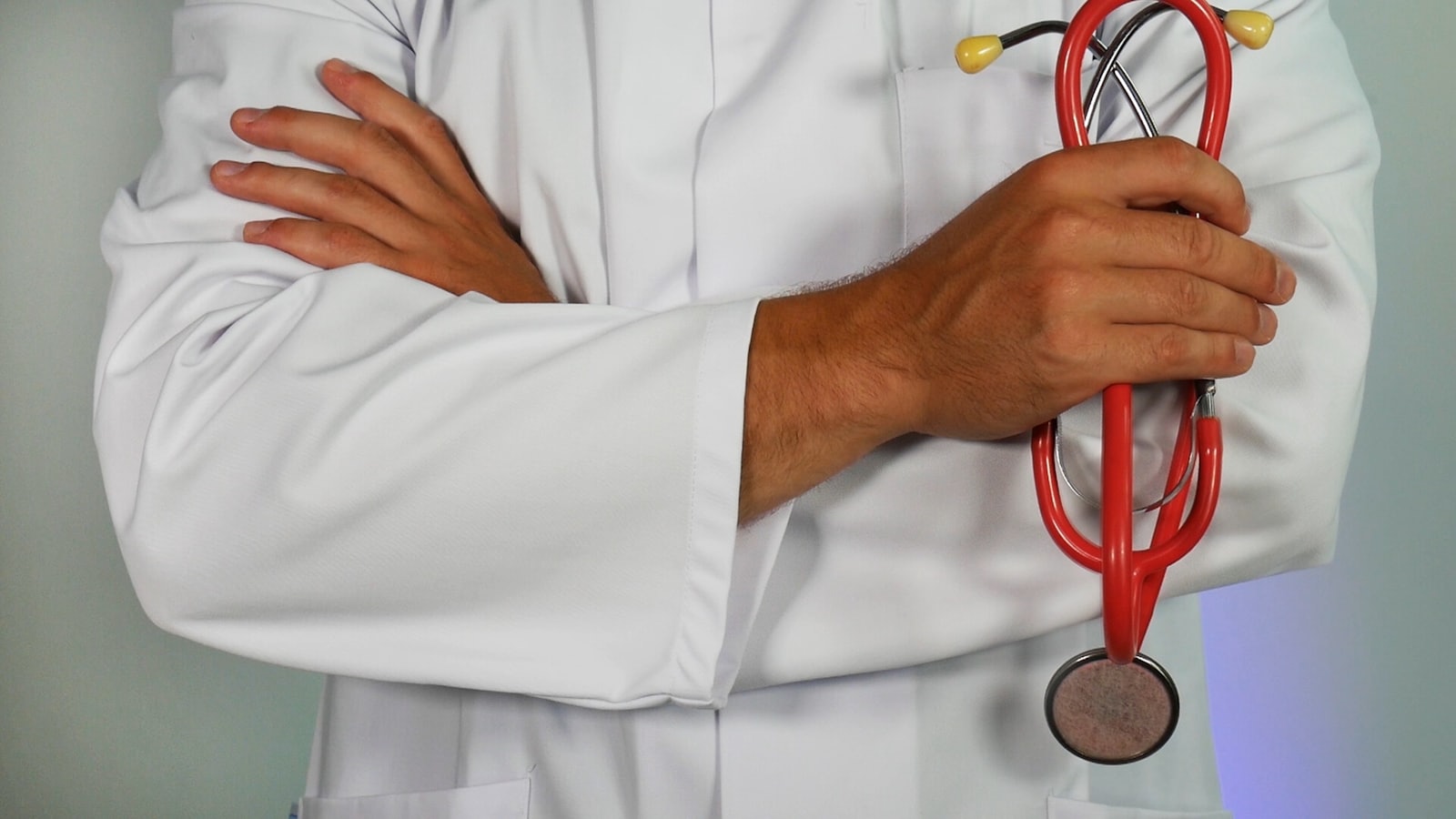 Doctor with stethoscope, arms crossed